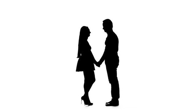 Guy with the girl hugs and looks at the sky. Silhouette. White background. Slow motion