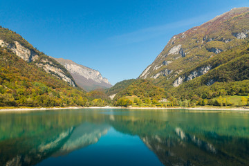 Fresh transparent emerald green water of Tenno lake in Trentino, Italy, Europe