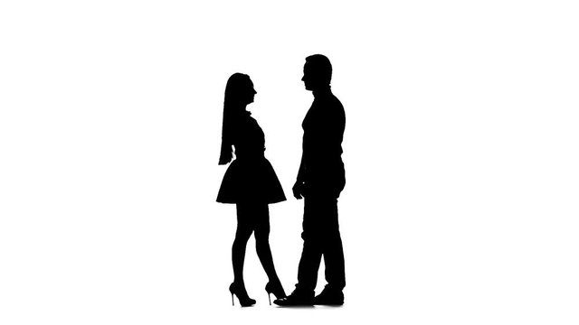 Pair of lovers kissing A white background. Silhouette. Slow motion
