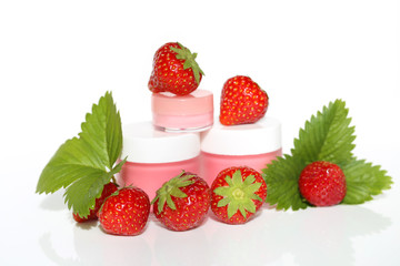 Face cream with strawberry extract.  strawberry cosmetic cream and ripe bright strawberries on white background. Organic Botanical Cosmetics Concept