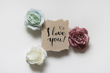 St. Valentine's Day background. Three roses and the inscription I love you