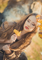 Fototapeta premium Sexy amazing lady girl nifty stylish dressed in autumn jacket with blond hairs and pout red lips with make up face posing sit for camera in central park spring forest meadow