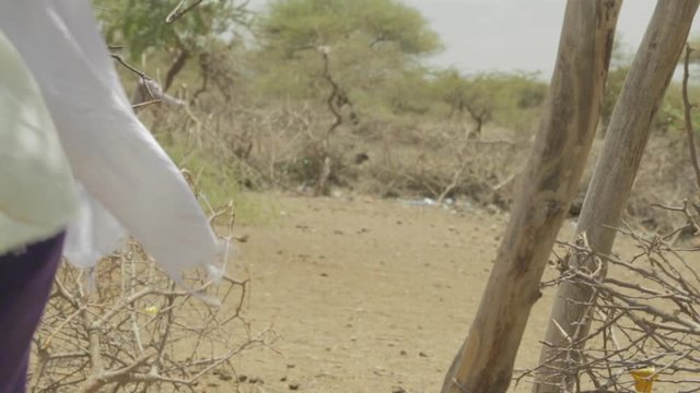 Masai woman walk into the bush.