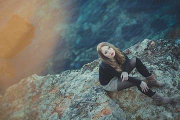 Seductive sexy lady girl with romantic pout red lips and pinky cheeks wearing stylish jacket dress and shorts with autumn boots posing at rocky beach sea side with make up on face i romantic episode