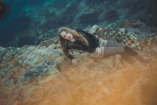 Seductive Sexy Lady Girl With Romantic Pout Red Lips And Pinky Cheeks Wearing Stylish Jacket Dress And Shorts With Autumn Boots Posing At Rocky Beach Sea Side With Make Up On Face I Romantic Episode