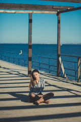 Seductive sexy lady girl with romantic pout red lips and pinky cheeks wearing stylish jacket dress and shorts with autumn boots posing on pier jetty sea side with make up on face i romantic episode