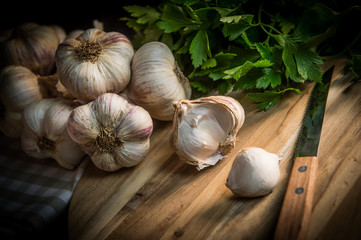 Garlic Cloves and Garlic Bulb on vintage wood background