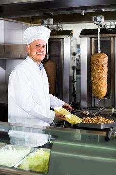 man chef serving fresh kebab