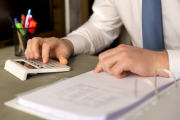 Successful business working overtime and calculating balance sheet.