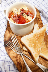 scrambled eggs with tomato, bacon bits and crushed pepper corn