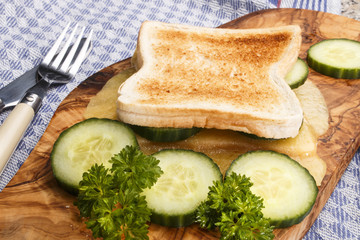 toasted bread with melted irish mild cheddar and cucumber slices