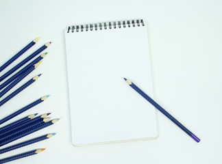 Blank white spiral bound paper drawing pad with color pencil. Isolated on white background