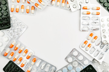 Medications and pills on a white background closeup shot with text space in the center