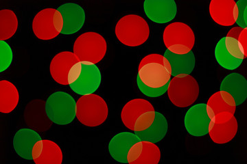 Red and green bokeh lights of Christmas garland. Blurred background.