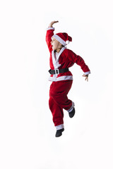 Little caucasian girl dressed as Santa Claus jumping on white background.