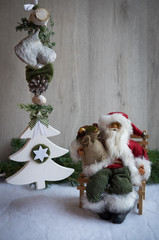 Fototapeta premium Christmas ornaments with snow, pine tree and Santa Claus