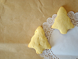 Christmas cookies on paper and white napkin.