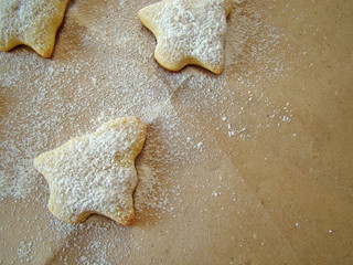 Christmas cookies on paper and powered sugar.