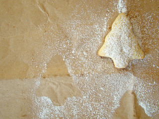 Christmas cookies on paper and powered sugar.