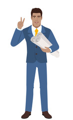 Businessman holding the project plans and showing victory sign