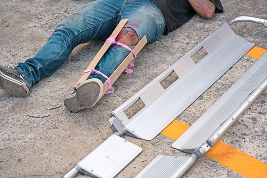 A Man broke his leg in an accident.
splint medical equipment using to transport stretcher.