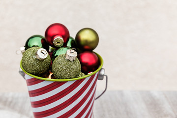 Closeup of Festive Small Balls Collected in Striped Bucket for Christmas