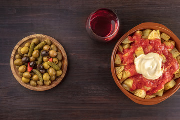 Tapas and wine. Patatas bravas, olives, and copy space