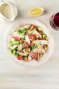 Chicken Caesar salad on light background with copyspace