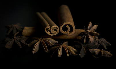 Star anise and cinnamon on black background