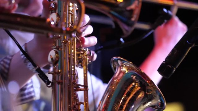 Pipes in the hands of musicians. Musicians playing wind instruments