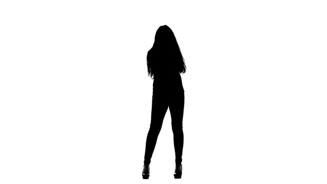 Woman sings incendiary songs into the microphone. White background. Silhouette. Slow motion