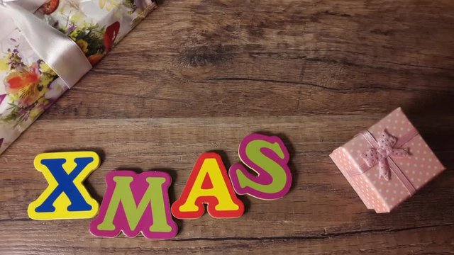 Xmas on a wooden table with gifts, Stop motion, top view shot