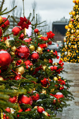 Christmas mood on the streets of the city Christmas tinsel, Christmas trees, balloons and other decorations.