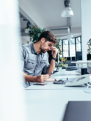 Tired young businessman in the office