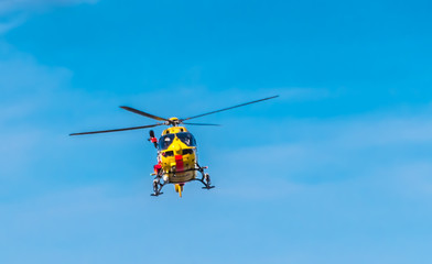 Fototapeta na wymiar A rescue helicopter in use on the North Sea coast.Ein Rettungshubschrauber im Einsatz an der Norseeküste.