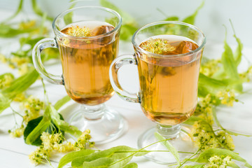 Linden herbal tea in transparent grog glass