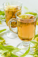 Linden herbal tea in transparent grog glass