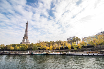 Paris, France - November, 2017. Seine in Paris with Eiffel tower on blue sky