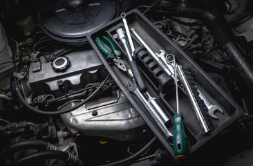 tools of auto mechanic with engine