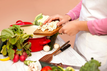 Obraz na płótnie Canvas Woman preparing cauliflower fresh vegetable for cooking