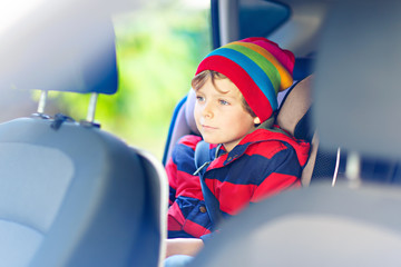 Portrait of preschool kid boy sitting in car