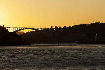The beautiful view over Porto in Portugal, golden sun shines above the river Do