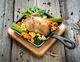 Grilled pheasant with bacon and spices and vegetables