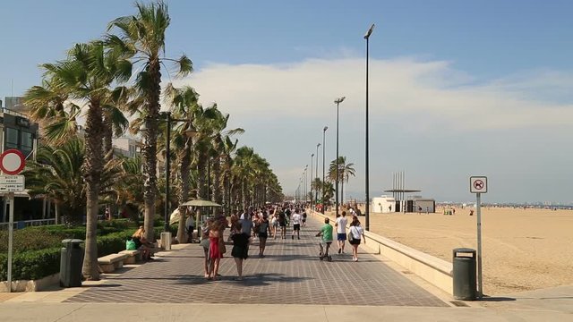 People walking along the beach bay 30 July 2017 in Valencia Spain