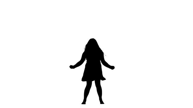 Girl is dancing energetically, having fun. White background. Silhouette. Slow motion