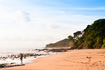Tourist walking under Smooth evening light at Nui beach on Koh Lanta, Krabi, Thailand