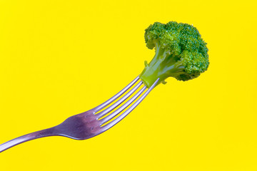 Broccoli planted on a metal fork.