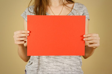 Girl holding red A4 blank paper horizontally. Leaflet presentation. Pamphlet hold hands. Woman show clear offset paper. Sheet template. Booklet design sheet display read first person.