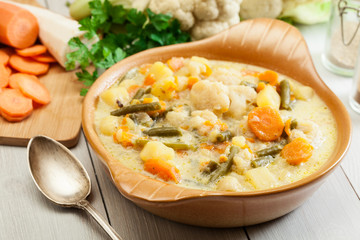 Vegetable soup with ingredients carrot, cauliflower, potato and