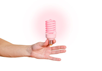 Closeup of man's hand holding energy saving lamp. Glows brightly with red light. Recycling,...